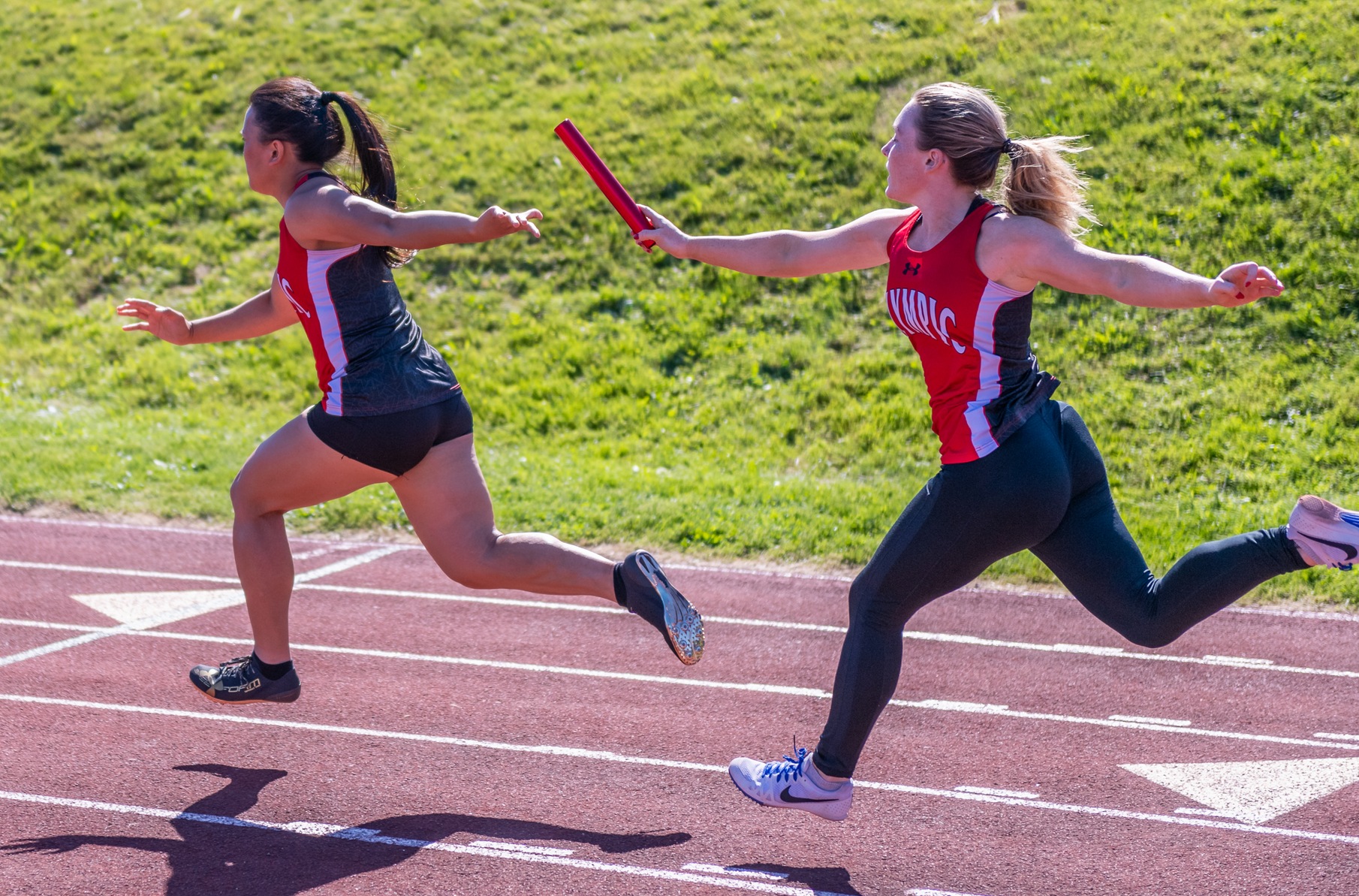 a handoff in a women's relay race
